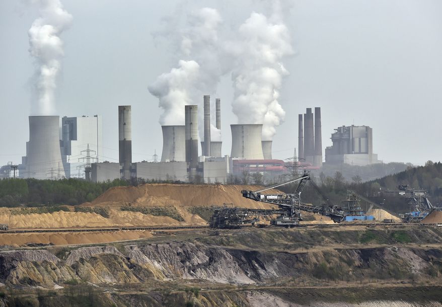FILE - In this April 3, 2014 file photo giant machines dig for brown coal at the open-cast mining Garzweiler in front of a smoking power plant near the city of Grevenbroich in western Germany. The U.N. weather agency says carbon dioxide levels in the atmosphere reached a record high in 2013. The World Meteorological Organization says the heat-trapping gas blamed for global warming was at global concentrations of 396 parts per million last year. That is an increase of 2.9 ppm from the previous year, which the Geneva-based agency reported Tuesday, Sept. 9, 2014 was the biggest year-to-year change in three decades. (AP Photo/Martin Meissner, File)