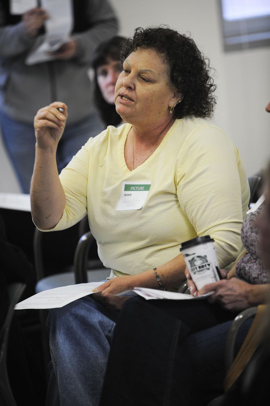 Carole Kiley questions a panel of VA Montana Health Care System representatives about the future of a possible women's clinic, Sept. 10, 2014, at the VA Clinic in Helena, Mont. (AP Photo/Independent Record. Thom Bridge)