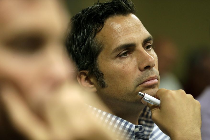 Independent U.S. Senate candidate Greg Orman talks to workers at a healthcare company, Wednesday, Sept. 10, 2014, in Overland Park, Kan. Orman is campaiging to unseat veteran Republican Sen. Pat Roberts. (AP Photo/Charlie Riedel)