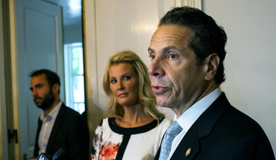 Gov. Andrew Cuomo, stands with his partner Sandra Lee, center, while addressing members of the media after casting a vote in the primary election Tuesday, Sept. 9, 2014, at the Presbyterian Church of Mount Kisco in Mount Kisco, N.Y. (AP Photo/Craig Ruttle)