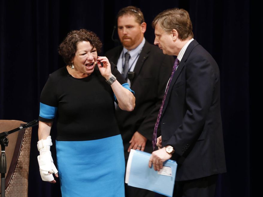 Supreme Court Associate Justice Sonya Sotomayor, left, greets Law Professor Robert Spoo before she speaks to University of Tulsa students and faculty in Tulsa, Okla., Wednesday, Sept. 10, 2014. (AP Photo/Tulsa World, James Gibbard)