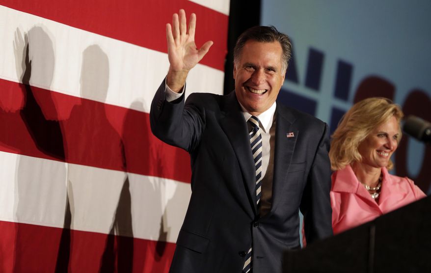 Former Republican presidential contender Mitt Romney, left, walks on stage with his wife, Ann Romney, during an event celebrating the 52nd birthday of New Jersey Gov. Chris Christie, Wednesday, Sept. 10, 2014, in East Brunkswick, N.J.  (AP Photo/Julio Cortez)