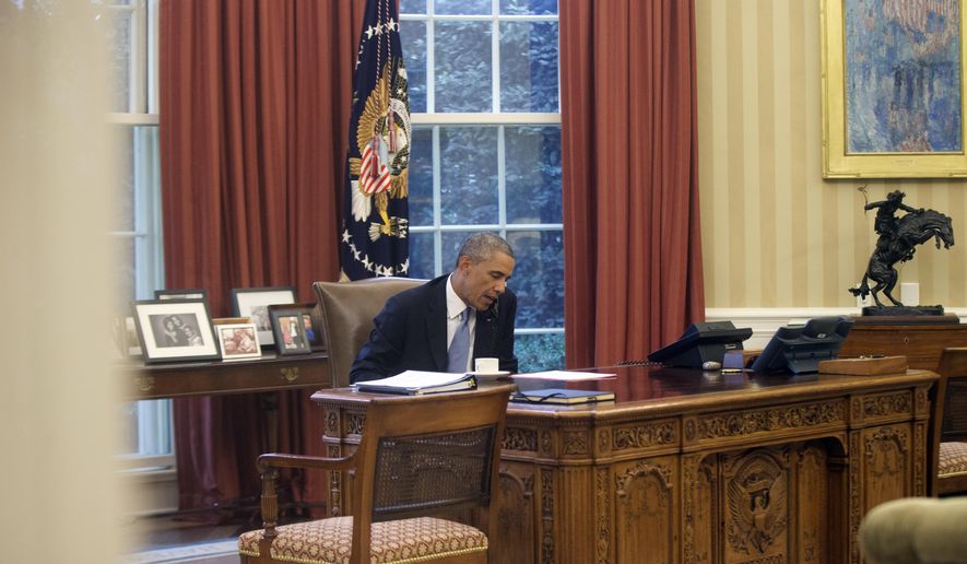 In this image made through a window of the Oval Office, President Barack Obama speaks on the phone to Saudi Arabia&#39;s King Abdullah from his desk at the White House in Washington, Wednesday, Sept. 10, 2014, ahead of his address to the nation tonight regarding Iraq and Islamic State group militants. (AP Photo/Charles Dharapak)