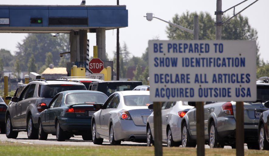 **FILE** A line of cars wait to enter the United States from Canada in Blaine, Wash., on July 21, 2009. (Associated Press)