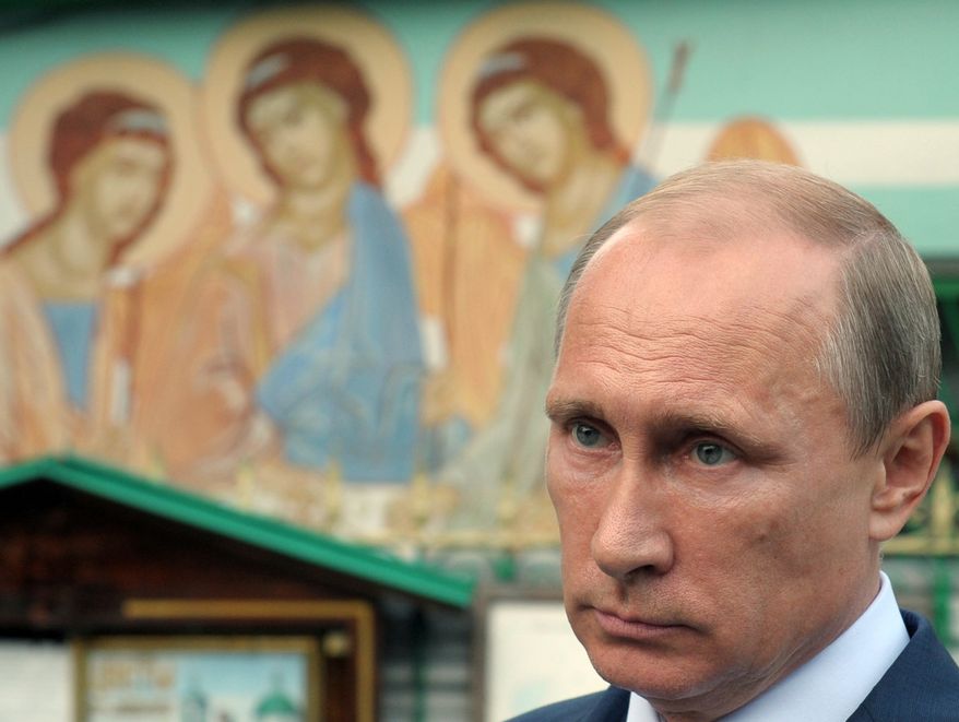 Russian President Vladimir Putin visits the Lifegiving Trinity Church in Moscow, Russia, Wednesday, Sept. 10, 2014. President Vladimir Putin said Wednesday that Russia will develop an array of new nuclear and conventional weapons to counter recent moves by the U.S. and NATO. (AP Photo/RIA-Novosti, Alexei Druzhinin, Presidential Press Service)