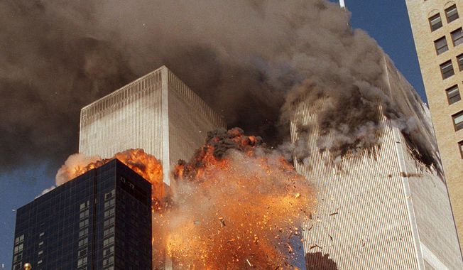 In this Sept. 11, 2001, file photo, smoke billows from World Trade Center Tower 1 and flames explode from Tower 2 as it is struck by United Airlines Flight 175, in New York. (AP Photo/Chao Soi Cheong, File)