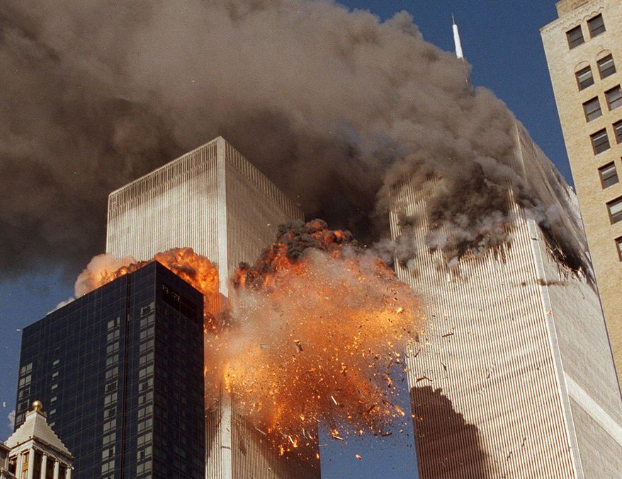 In this Sept. 11, 2001, file photo, smoke billows from World Trade Center Tower 1 and flames explode from Tower 2 as it is struck by United Airlines Flight 175, in New York. (AP Photo/Chao Soi Cheong, File)