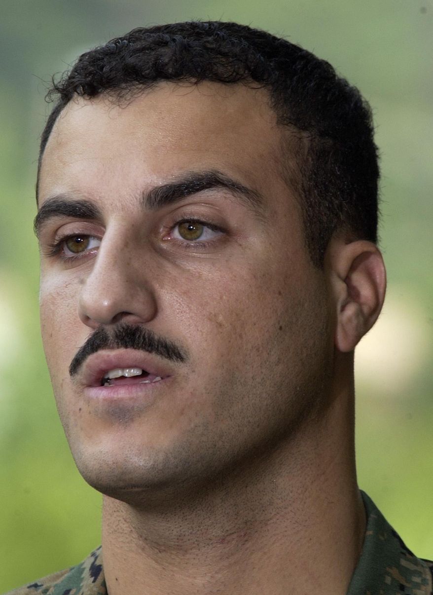 FILE - In this July 19, 2004 file photo, Marine Cpl. Wassef Ali Hassoun makes a statement to the press outside Quantico Marine Base in Quantico, Va. A hearing officer has recommended a court martial for Hassoun, a Marine accused of deserting his unit a decade ago in Iraq and later winding up in Lebanon for eight years, a defense lawyer said Thursday, Sept. 11, 2014. (AP Photo/Steve Helber, File)