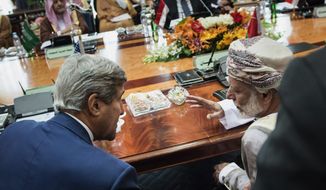 Oman Foreign Minister Yusuf bin Alawi bin Abdullah and U.S. Secretary of State John F. Kerry talk before a meeting of the Gulf Arab region in Jiddah, Saudi Arabia, Thursday. Mr. Kerry sought to pin down Middle Eastern allies on what support they are willing to give to the new U.S. plan to beat back the Islamic State militant group. (Associated Press)