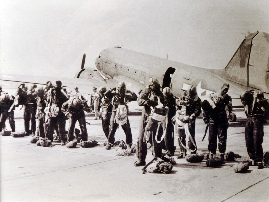 In this July 20, 1945, photo provided by the Pendleton Oregon National Guard, the 555th Parachute Infantry Battalion prepares to make its first jump on a forest fire in the Meadow Lakes National Forest in Idaho. Thanks to the Battalion, the only African American parachute unit during World War II, Pendleton, Ore., is now being looked at as a potential African American historical site. (AP Photo/Oregon National Guard via East Oregonian)