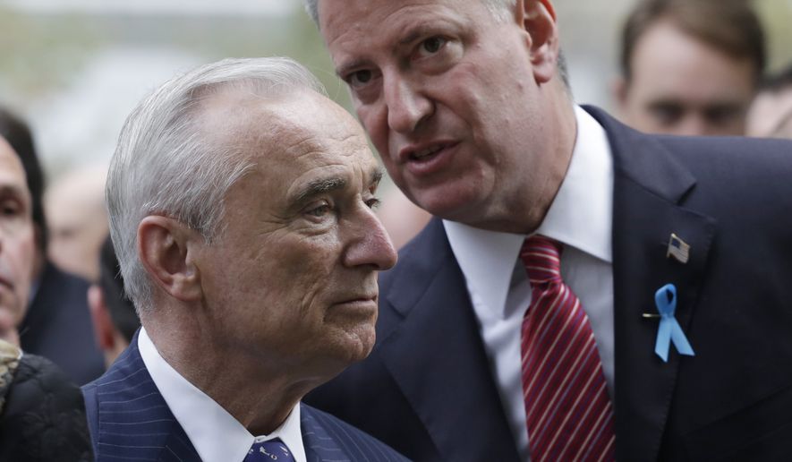 New York City Police Commissioner Bill Bratton and Mayor Bill de Blasio talk during memorial observances held at the site of the World Trade Center in New York, Thursday, Sept. 11, 2014.  Family and friends of those who died read the names of the nearly 3,000 people killed in New York, at the Pentagon and near Shanksville, Pennsylvania.(AP Photo/Mark Lennihan, Pool) 