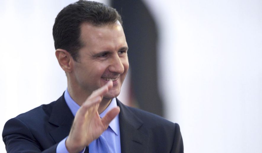In this Wednesday, July 16, 2014, file photo released by the Syrian official news agency SANA, Syria&#39;s President Bashar Assad waves to his supporters upon his arrival to the presidential palace to take the oath of office for his third seven-year term in Damascus, Syria. (AP Photo/SANA, File)
