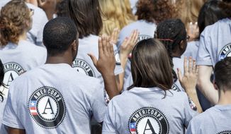 Hundreds of new volunteers are sworn in for duty at a ceremony marking the 20th anniversary of the AmeriCorps national service program on the South Lawn of the White House on Sept. 12. (AP Photo/J. Scott Applewhite)