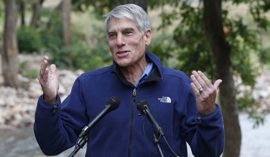 U.S. Sen. Mark Udall, D-Colo., speaks during a joint news conference with Trout Unlimited by the shore of the St. Vrain Creek, which was disastrously flooded a year ago this week, in Lyons, Colo., Friday, Sept. 12, 2014. The group spoke to mark the 50th year of the Land and Water Conservation Fund, a federal program which was created to use offshore oil and gas royalties to improve outdoor recreation opportunities and conserve irreplaceable lands. (AP Photo/Brennan Linsley) ** FILE **