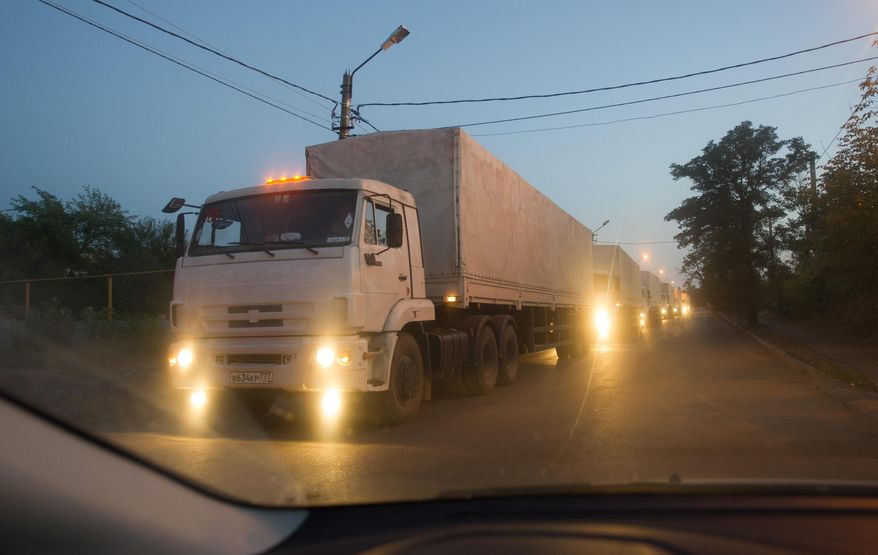 Russian trucks, carrying humanitarian aid for eastern Ukraine, are driven to a border check point in the town of Donetsk, Rostov-on-Don region, Russia, early Saturday, Sept. 13, 2014. The second convoy of Russian trucks that entered rebel-held territory in eastern Ukraine earlier Saturday, is reportedly filled with almost 2,000 tons of humanitarian aid. (AP Photo)
