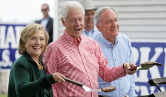 Mrs. Clinton, former President Bill Clinton and U.S. Sen. Tom Harkin work the grill during the 37th annual &quot;steak fry&quot; fundraiser. Mrs. Clinton teased the crowd about her plans, saying her focus is on her future grandchild and &quot;then, of course, there is that other thing.&quot;