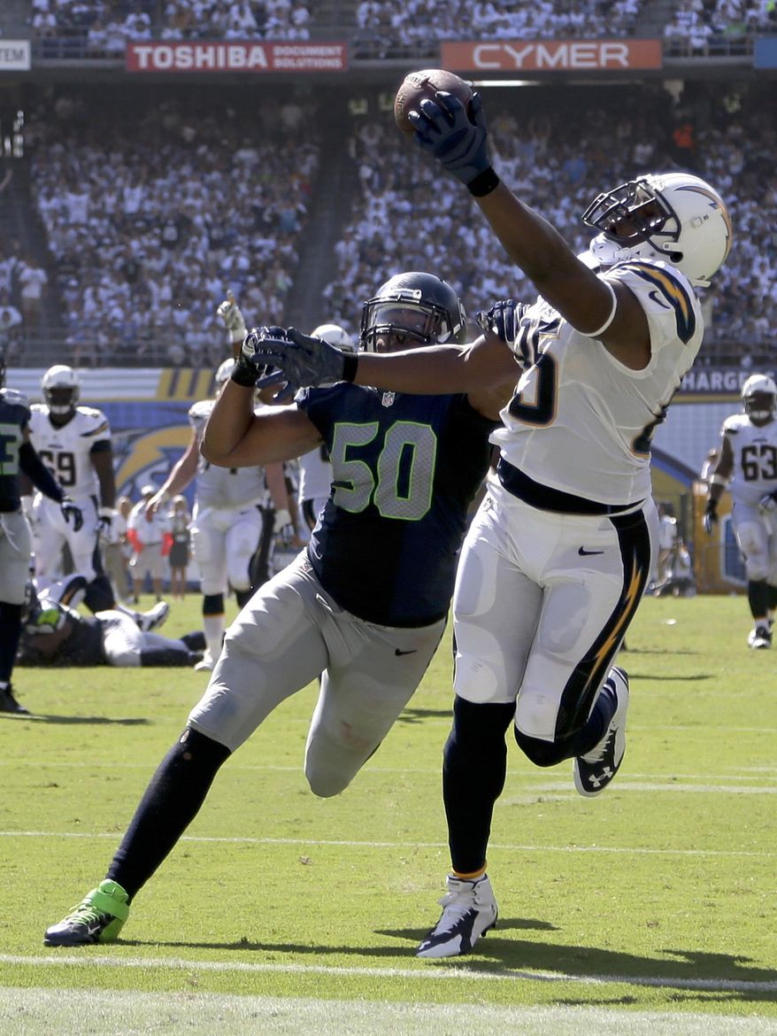 San Diego Chargers tight end Antonio Gates scores past Seattle Seahawks outside linebacker K.J. Wright during the second half of an NFL football game on Sunday, Sept. 14, 2014, in San Diego. (AP Photo/Gregory Bull)