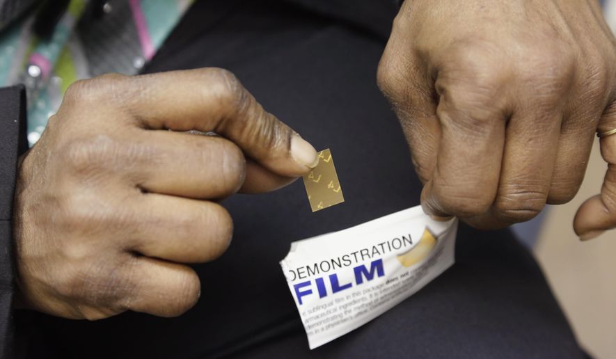 Shavonne Bullock, a recovering heroin addict, holds a demonstration dose of the medication Suboxone during an appointment at the West Division Family Health Center in Chicago on March 11, 2013. Each dose is incorporated on a dissolvable film, which is placed below the tongue where is dissolves and is absorbed into the bloodstream. Suboxone helps suppress withdrawal symptoms and reduce cravings for people recovering from addiction to opioid drugs. (Associated Press) **FILE**