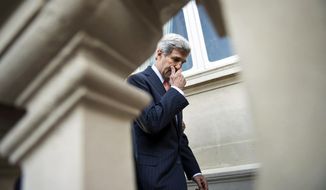 US Secretary of State John Kerry  leaves after a family photo at the conference intended to come up with an international strategy against  Islamic State extremists in Paris, Monday, Sept. 15, 2014. As diplomats from around the world sought a global strategy to fight Islamic State extremists, Iran ruled out working with any international coalition, saying it had rejected American requests for cooperation against the militants. (AP Photo/Brendan Smialowski; Pool)