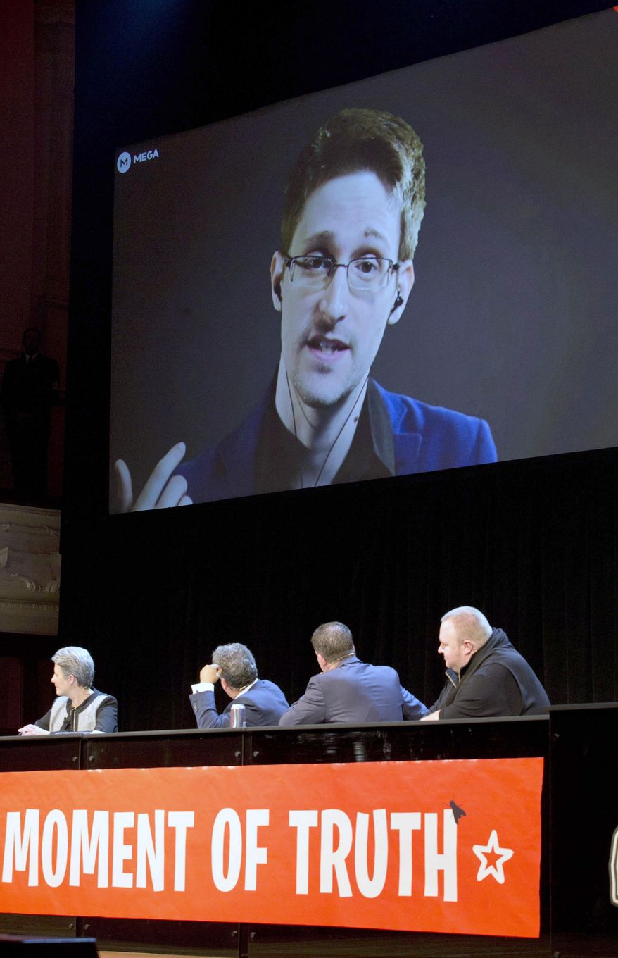 Former National Security Agency systems analyst turned leaker Edward Snowden appears via video link from Russia to hundreds of people in Auckland, New Zealand, Town Hall, Monday, Sept. 15, 2014. Snowden said the NSA is collecting mass surveillance data on New Zealanders through its XKeyscore program and has set up a facility in the South Pacific nation to tap into vast amounts of data. (AP Photo/New Zealand Herald, Brett Phibbs) NEW ZEALAND OUT, AUSTRALIA OUT