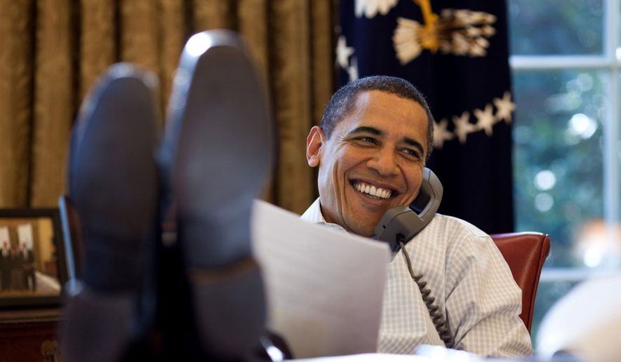 President Obama talks on the phone from the Oval Office in 2009. (White House photo)