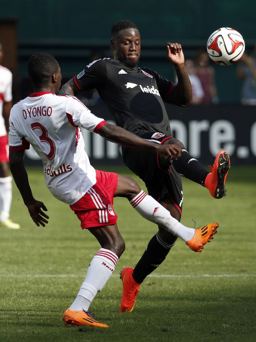 New York Red Bulls defender Ambroise Oyongo (3) and D.C. United forward Eddie Johnson, right, go for the ball during the second half of an MLS soccer match on Sunday, Aug. 31, 2014, in Washington. United won 2-0. (AP Photo/Alex Brandon)