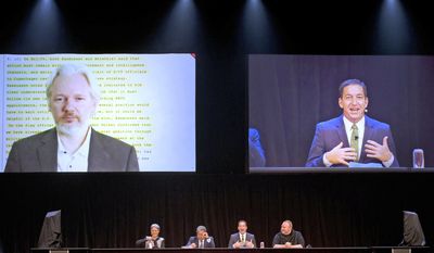 WikiLeaks founder Julian Assange, top left, appears via video link from London as international human rights lawyer Laila Harre, bottom left, Robert Amsterdam, second left, journalist and author Glenn Greenwald, second right and projected top right, and Kim Dotcom, right, attend a political forum at a town hall in Auckland, New Zealand, Monday, Sept. 15, 2014. (AP Photo/New Zealand Herald, Brett Phibbs) ** FILE **