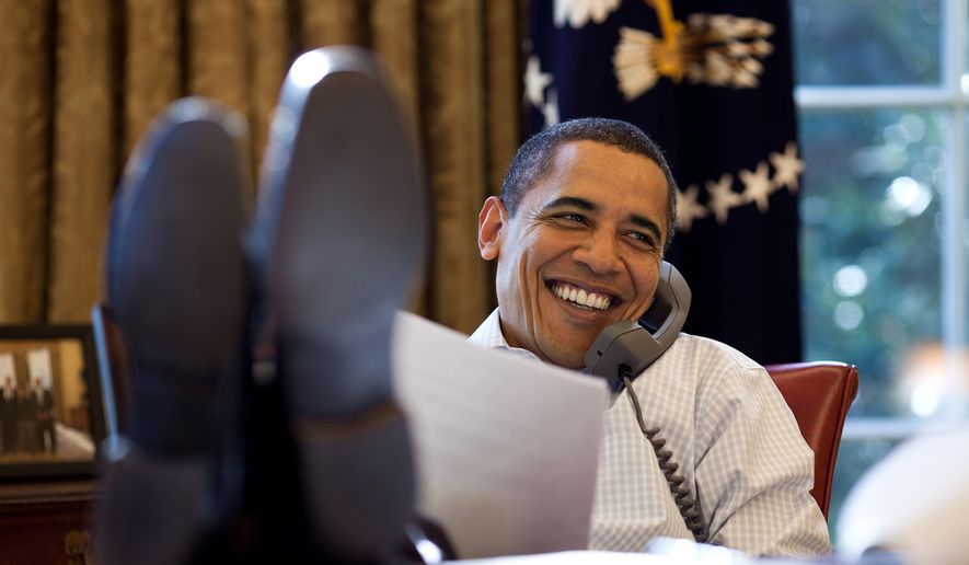 President Barack Obama smiles while talking on the phone in the Oval Office, Saturday, Dec. 12, 2009. (Official White House Photo by Pete Souza)
