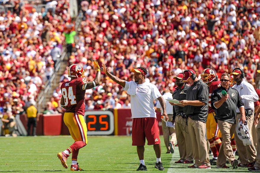 Washington Redskins tight end Niles Paul (84) gets a high five from Washington Redskins wide receiver Santana Moss (89) as the Washington Redskins play the Jacksonville Jaguars at FedExField, Landover, Md., Monday, September 9, 2013. (Andrew Harnik/The Washington Times)