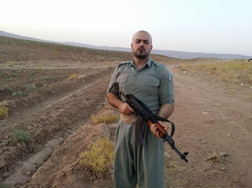 In this image provided by Shaho Pirani shows Shaho Pirani posing with an automantic weapon near the village of Koya in Iraqi Kurdistan in June 2014. The Iranian Kurd living in Denmark, was on a month-long training camp for the Kurdish diaspora organized by Iranian branch of the Kurdistan Democratic Party. He joined Kurds from Norway, Switzerland and Britain for a crash-course on politics followed by weapons training. Shaho Pirani says he's just a phone call away from leaving his quiet life in Denmark and joining Kurdish forces battling against Islamic State militants in Iraq. The 30-year-old Kurd, who fled from Iran with his older brother in 1991, says he feels a moral duty to help the Peshmerga, the armed forces of the Kurdistan Regional Government, to fight the "psychopaths" of the IS group. (AP Photo/Shaho Pirani)