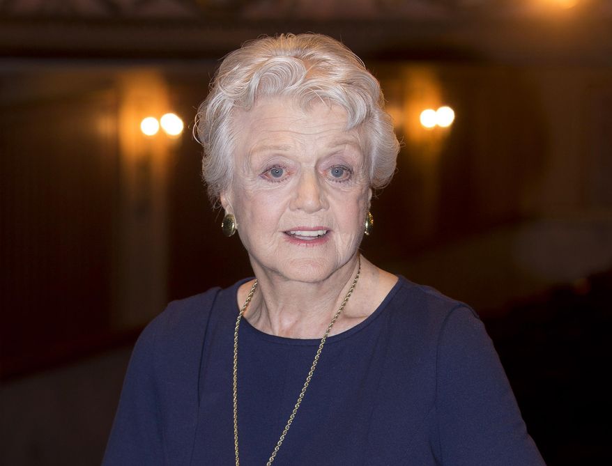 In this Jan. 23, 2014 file photo, actress and singer Angela Lansbury is photographed on stage at the Gielgud Theatre in central London, as she returns to the West End this spring for the first time in nearly 40 years, with the play, "Blithe Spirit," by Noel Coward. (Photo by Joel Ryan/Invision/AP, File)