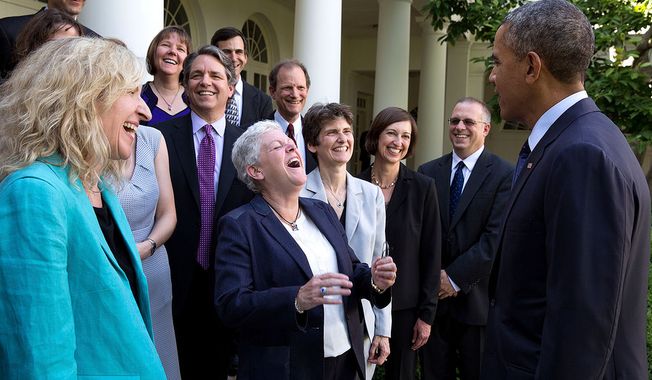 President Barack Obama jokes with Environmental Protection Agency Administrator Gina McCarthy and EPA staff members who worked on the power plant emissions standards, in the Rose Garden of the White House, June 2, 2014. (Official White House Photo by Pete Souza)