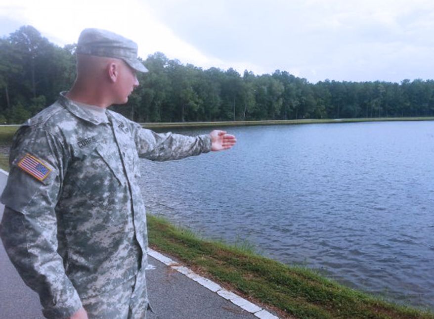 Pfc. Nathan Currie, from the 756th Explosive Ordnance Disposal Company, pulled a woman from a sinking vehicle in alligator-infested water at Fort Stewart, Georgia. (image: U.S. Army)