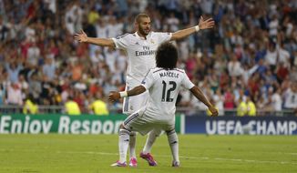 Real Madrid&#x27;s Karim Benzema celebrates with Real Madrid&#x27;s Marcelo after scoring his side&#x27;s fifth goal during the Champions League Group B soccer match between Real Madrid and Basel at the Santiago Bernabeu stadium in Madrid, Spain, Tuesday Sept. 16, 2014. (AP Photo/Daniel Ochoa de Olza)