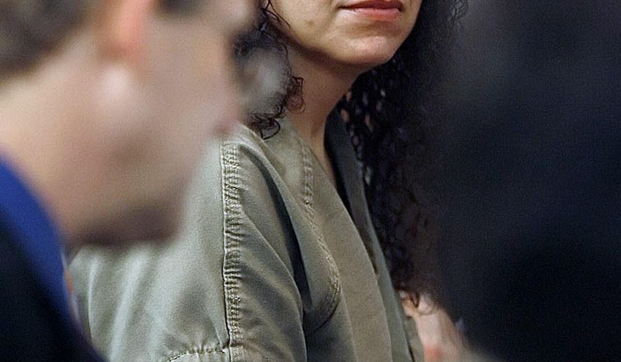 FILE - In this April 24, 2012 file photo, Hannah Overton takes her seat for the second day of her appeals case at the Nueces Courthouse in Corpus Christi, Texas. The Texas Court of Criminal Appeals on Wednesday, Sept. 17, 2014, overturned Overton's conviction of capital murder in the 2006 salt poisoning death of her 4-year-old foster son. She has been granted a new trial. (AP Photo/Corpus Christi Caller-Times, Todd Yates, File) MANDATORY CREDIT ; TV OUT; MAGS OUT