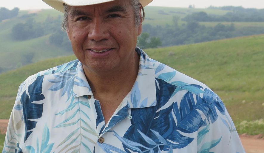 FILE - This July 9, 2014 file photo shows Mandan, Hidatsa and Arikara Nation Chairman Tex Hall near Mandaree, N.D. A new report is delving into the personal financial dealings of Hall, who oversaw the transformation of North Dakota's Fort Berthold Indian Reservation into a rich oil-producing enterprise. Hall didn't get enough votes in the Tuesday, Sept. 16, 2014 primary election to continue as chairman. (AP Photo/Josh Wood, File))
