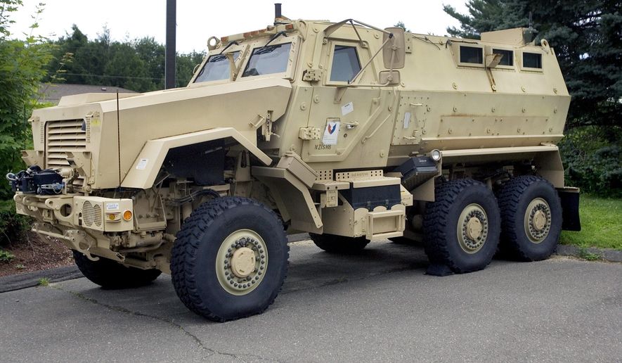 FILE- In this July 16, 2014 file photo, a Mine-Resistant Ambush Protected vehicle sits in front of police headquarters in Watertown, Conn. The L.A. Unified&#39;s School District police department received a MRAP vehicle like this one through a federal program. School police departments across the country have taken advantage of free military surplus gear, stocking up on mine resistant vehicles, grenade launchers and scores of M16 rifles. At least 26 school districts across the country participate in the Pentagon’s surplus program, which has come under scrutiny after a militarized police response to protests in Ferguson, Missouri. (AP Photo/The Republican-American, Steven Valenti, File)