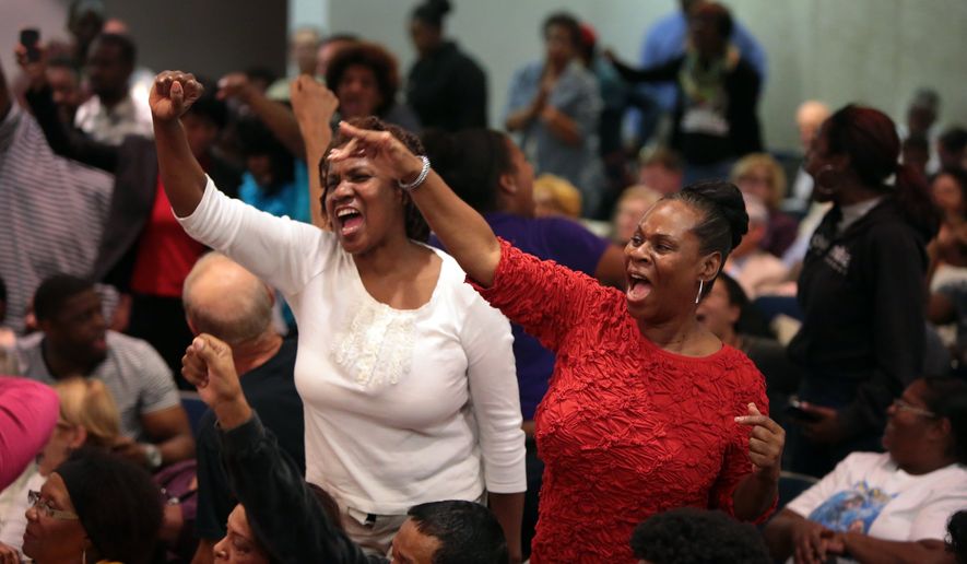 Ferguson protesters chant &quot;Arrest Darren Wilson!&quot; during at a meeting of the St. Louis County Council on Tuesday, Sept. 16, 2014 in Clayton. (AP Photo/St. Louis Post-Dispatch, Robert Cohen)