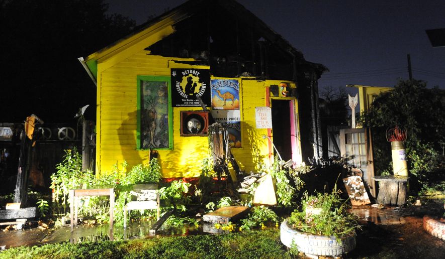 The roof of a house is damaged by Detroit Heidelberg Project outdoor art installation on Thursday, Sept. 18, 2014 in Detroit. The cause is under investigation. Tyree Guyton founded the Heidelberg Project on Detroit's east side in 1986 as a response to urban decay. The Heidelberg Project has boosted security in the area following a string of suspicious fires that started last year. (AP Photo/Detroit News, David Coates) DETROIT FREE PRESS OUT; HUFFINGTON POST OUT