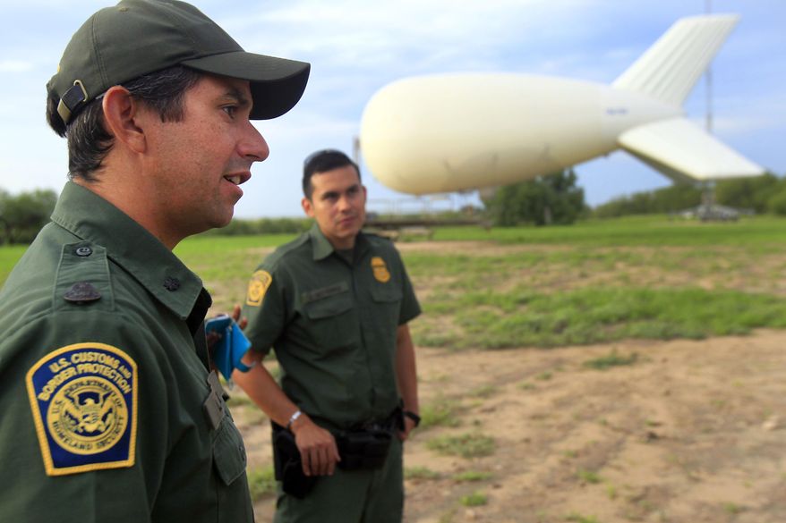 Assistant patrol agent in charge Lee Allbee, right, talks about the aerostat used by Border Patrol to look for smugglers and illegal crossings in the Rio Grande Valley, Friday Sept. 5, 2014 at Penitas, Texas. Since last November, the Border Patrol has stationed five surveillance sky cameras in the Rio Grande Valley area _ one in Penitas, two near Rio Grande City and two near Falfurrias, said agency spokesman Joe Gutierrez Jr. (AP Photo/The Monitor, Gabe Hernandez) MAGS OUT; TV OUT