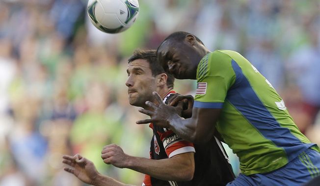Seattle Sounders&#x27; Jhon Kennedy Hurtado, right, and D.C. United&#x27;s Chris Pontius, left, vie for a header in the first half of an MLS soccer match, Wednesday, July 3, 2013, in Seattle. (AP Photo/Ted S. Warren)