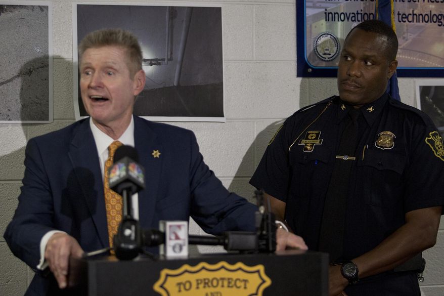 Flint Police Chief James W. Tolbert, right, listens as Genesee Co. Sheriff Robert Pickell addresses the media during a news conference discussing the Flint water theft investigations on Wednesday, Sep. 17, 2014 in Flint at the Police Headquarters. Flint authorities say they're investigating about 50 cases of water service theft and they're cracking down on those responsible. (AP Photo/The Flint Journal, Erin Kirkland) LOCAL TELEVISION OUT; LOCAL INTERNET OUT