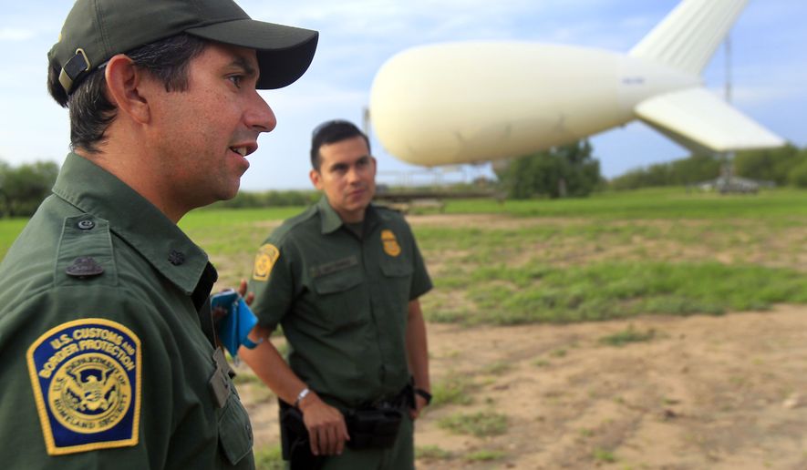Assistant patrol agent in charge Lee Allbee, right, talks about the aerostat used by Border Patrol to look for smugglers and illegal crossings in the Rio Grande Valley, Friday Sept. 5, 2014 at Penitas, Texas. Since last November, the Border Patrol has stationed five surveillance sky cameras in the Rio Grande Valley area _ one in Penitas, two near Rio Grande City and two near Falfurrias, said agency spokesman Joe Gutierrez Jr. (AP Photo/The Monitor, Gabe Hernandez) MAGS OUT; TV OUT