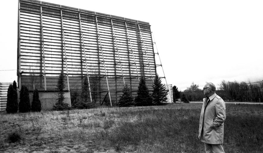 ADVANCE FOR SUNDAY, SEPT. 21- In a fall 1987 file photo, Paul Florence, vice-president of the Drive-In Theater Corp., looks at the back side of the movie screen at the Airport Drive-In Theatre in Marquette, Mich., shortly before the Marquette County Board approved purchasing and razing the theatre. Plowed under by an ever-building wave of technology, Marquette County's once popular three outdoor theaters reside in what's known today as the drive-in theater "graveyard." (AP Photo/The Mining Journal)