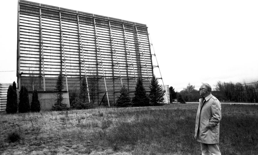 ADVANCE FOR SUNDAY, SEPT. 21- In a fall 1987 file photo, Paul Florence, vice-president of the Drive-In Theater Corp., looks at the back side of the movie screen at the Airport Drive-In Theatre in Marquette, Mich., shortly before the Marquette County Board approved purchasing and razing the theatre. Plowed under by an ever-building wave of technology, Marquette County&#39;s once popular three outdoor theaters reside in what&#39;s known today as the drive-in theater &amp;quot;graveyard.&amp;quot; (AP Photo/The Mining Journal)