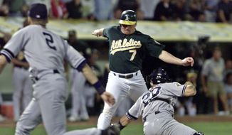 In this Oct. 13, 2001, file photo, Oakland Athletics&#x27; Jeremy Giambi, center, is tagged out at home by New York Yankees&#x27; Jorge Posada, right, during Game 3 of the American League Division Series in Oakland, Calif.  (AP Photo/Eric Risberg, File) **FILE**
