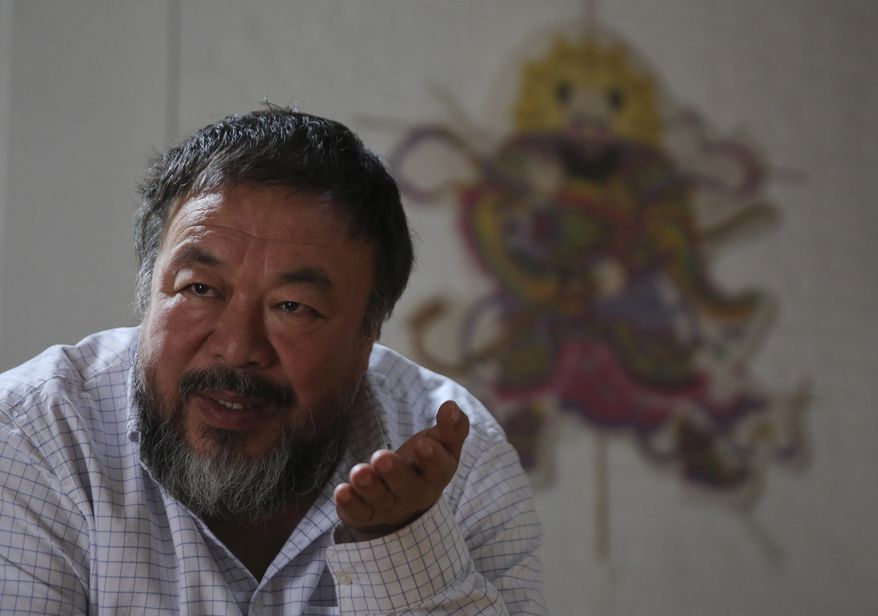 In this Tuesday, Sept. 16, 2014 photo, Chinese outspoken artist Ai Weiwei speaks during an interview at his home in Beijing, China. China’s best-known artist dissident Ai blasted his country’s Communist government for losing its principles and using underhanded ploys to try to silence critics. (AP Photo/Andy Wong)
