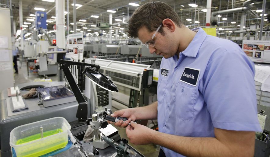 This Tuesday, Sept. 9, 2014 photo shows Jonah Devorak testing the dimensions on a high-pressure valve at Swagelok Co. in Strongsville, Ohio. Devorak was stuck in a “dead-end job” at a suburban Cleveland restaurant where he’d been washing dishes and manning the grill since he was 16. His outlook turned around after hearing about a program at Cuyahoga Community College that trains students for manufacturing jobs at a company that had openings for dozens of machine operators. He spent two months training to operate computer-controlled machines and then another two month internship that landed him a full-time job this year at Swagelok, a Cleveland-area maker of high-pressure valves and fittings. (AP Photo/Tony Dejak)