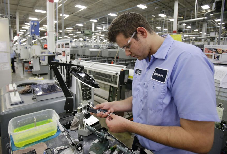 This Tuesday, Sept. 9, 2014 photo shows Jonah Devorak testing the dimensions on a high-pressure valve at Swagelok Co. in Strongsville, Ohio. Devorak was stuck in a “dead-end job” at a suburban Cleveland restaurant where he’d been washing dishes and manning the grill since he was 16. His outlook turned around after hearing about a program at Cuyahoga Community College that trains students for manufacturing jobs at a company that had openings for dozens of machine operators. He spent two months training to operate computer-controlled machines and then another two month internship that landed him a full-time job this year at Swagelok, a Cleveland-area maker of high-pressure valves and fittings. (AP Photo/Tony Dejak)