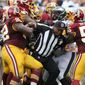 Philadelphia Eagles&#39; Jason Peters, right, and Washington Redskins&#39; Chris Baker, left, tussle after a fourth-quarter play as line judge Darryll Lewis tries to break it up during an NFL football game Sunday, Sept. 21, 2014, in Philadelphia. Both players were ejected. Philadelphia won 37-34. (AP Photo/Philadelphia Daily News, David Maialetti)